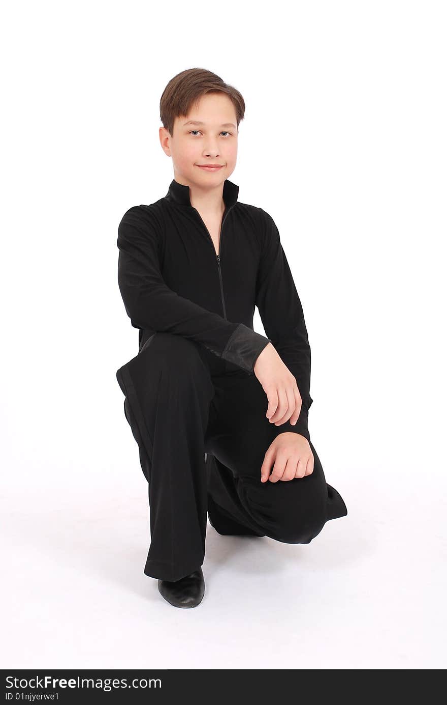 Boy in black costume posing in studio on white background