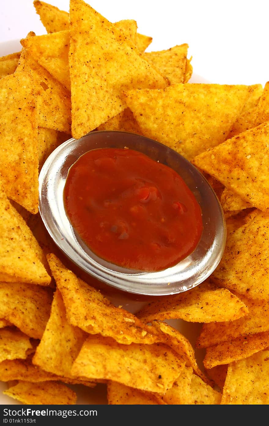 Salsa dip in a bowl on brown background