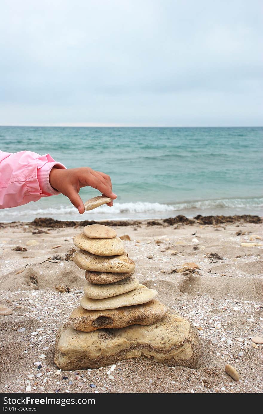 Stack of pebbles over sea background