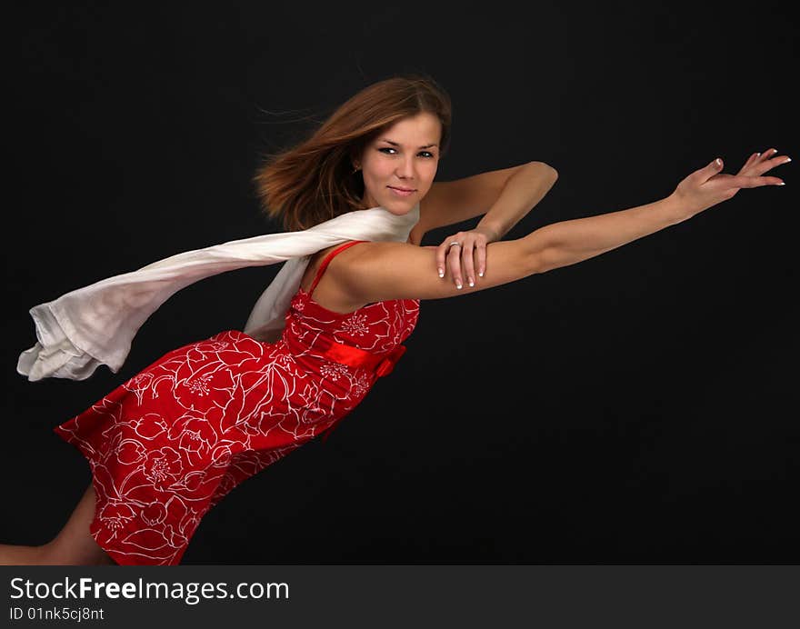 Portrait of elegant young flexible woman in red-white outfit with white scarf