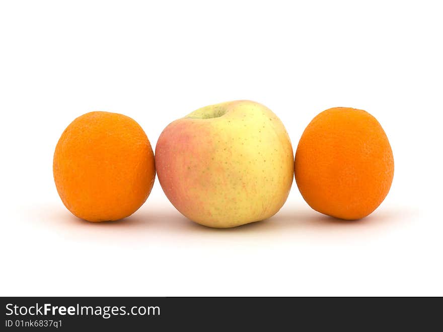 Apple and oranges on the white background