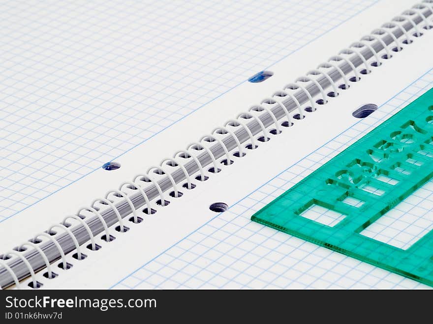 Spiral notebook with blue grid. Selective focus