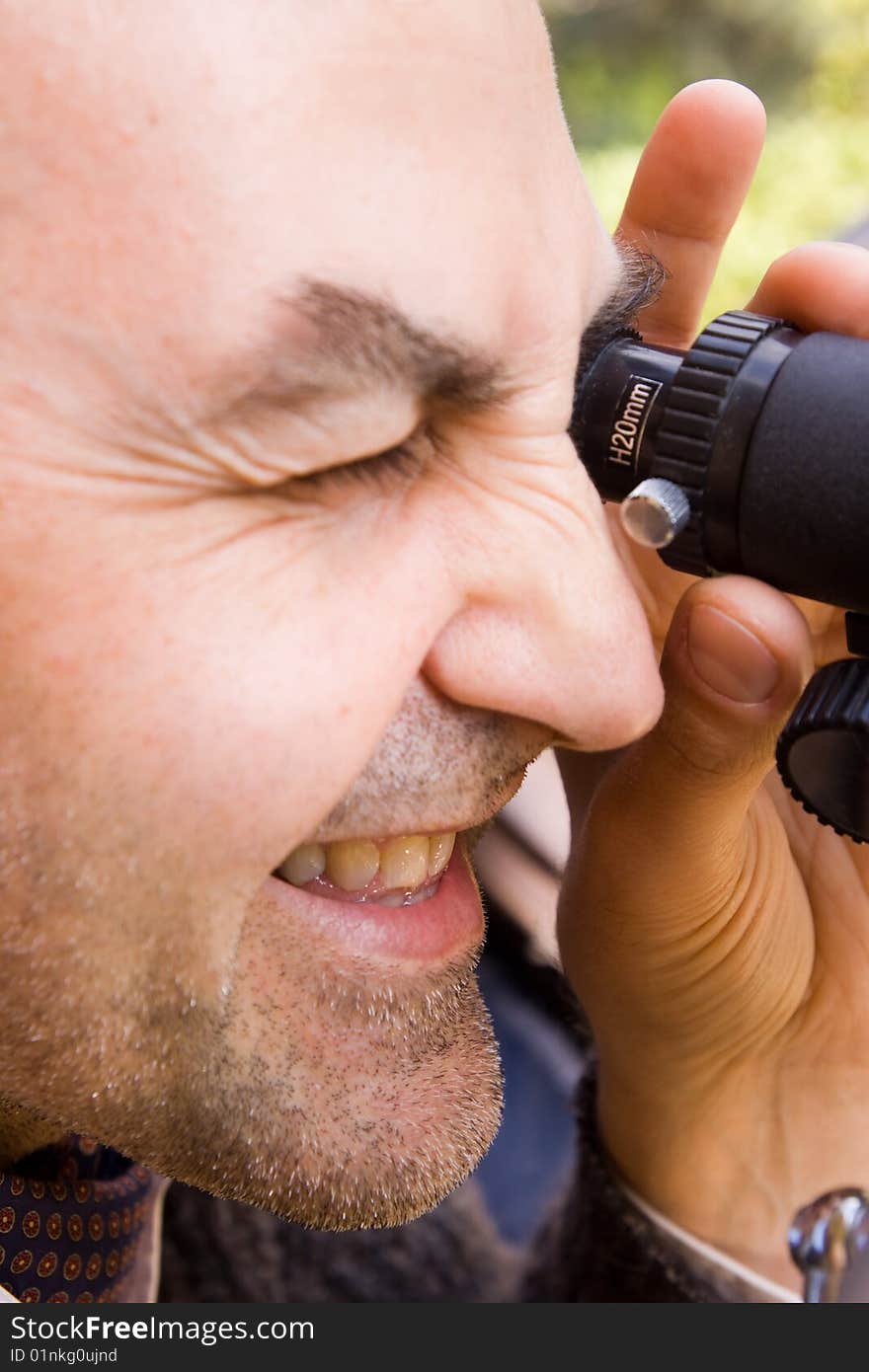 Scientist observing through his microscope. Scientist observing through his microscope