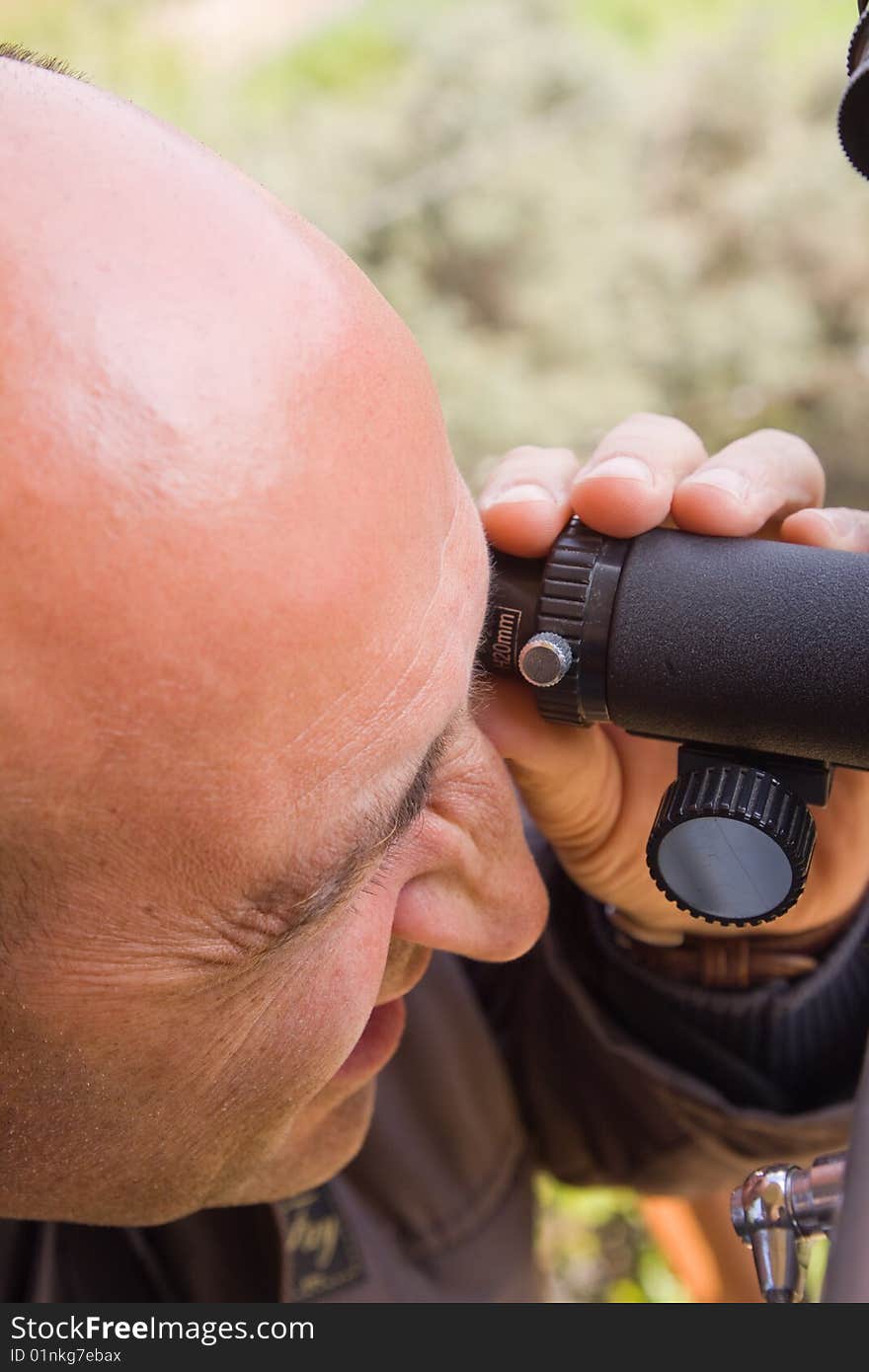 Scientist observing through his microscope. Scientist observing through his microscope