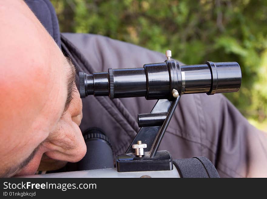 Scientist observing through his microscope. Scientist observing through his microscope