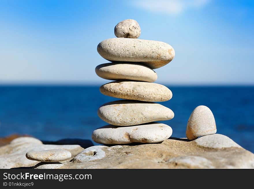 Several white pebbles one after another on a rock. Several white pebbles one after another on a rock