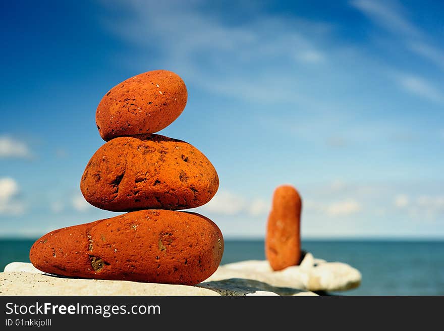 Several red pebbles one after another on a rock. Several red pebbles one after another on a rock