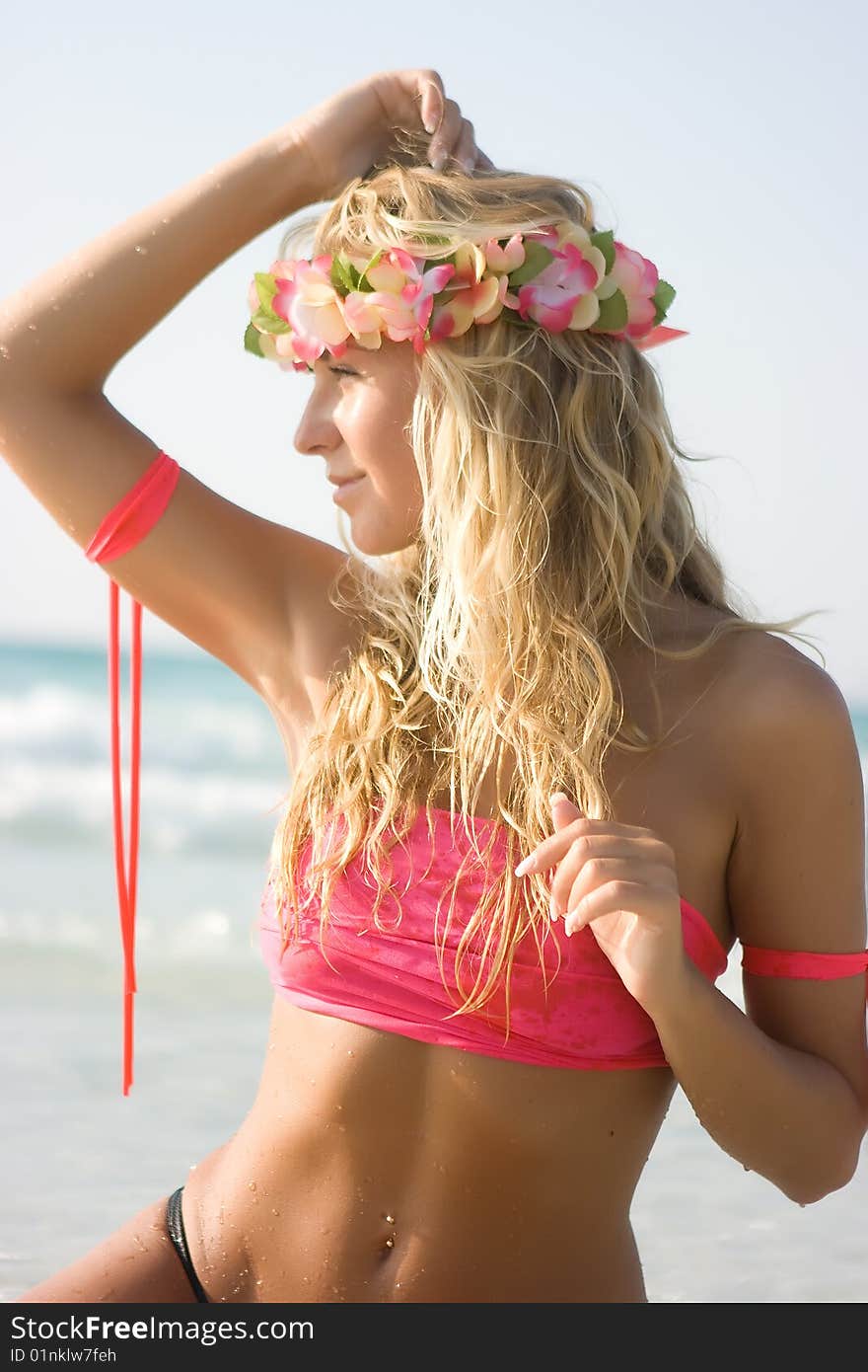 Blonde lady sitting in the sea water. Blonde lady sitting in the sea water