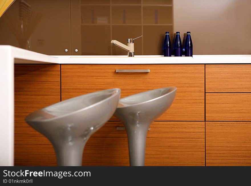 Interior of kitchen with a sink and chairs