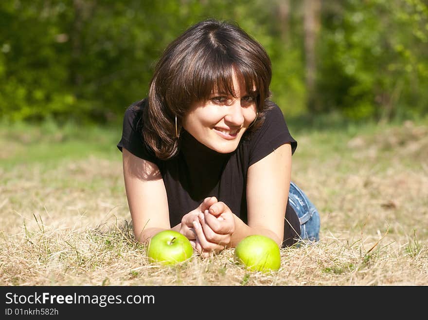 Beautiful girl with apples in a sunlight