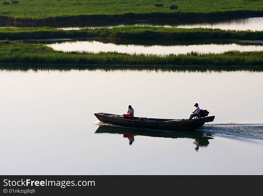 A boat is sailing on the lake