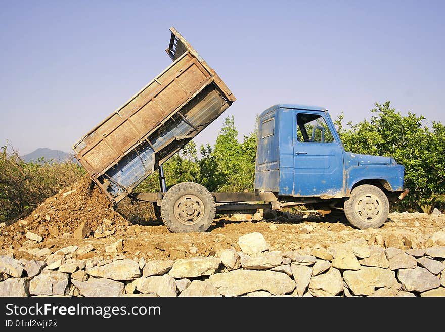 Tractor transport stone on the stone Road