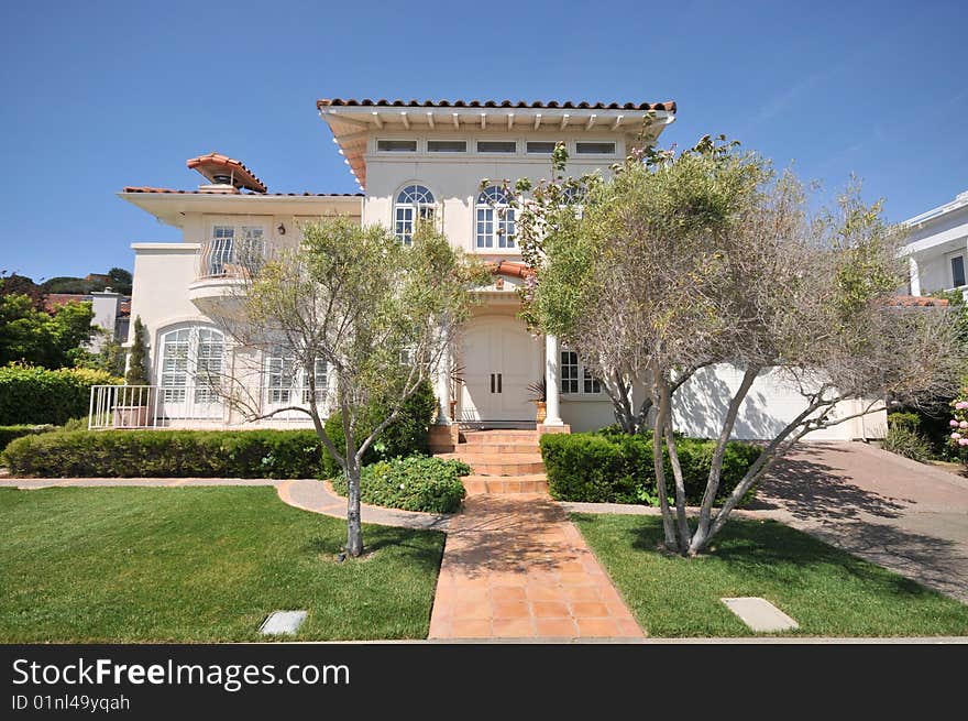 Two trees frame the walkway to a house