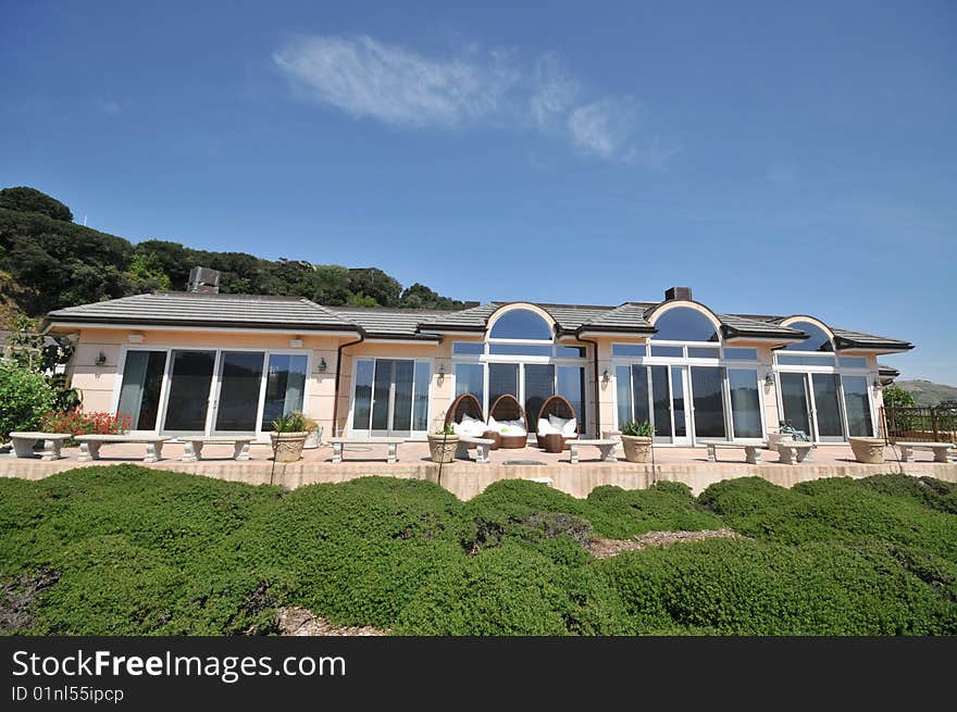 Large single level house with shrubs in front