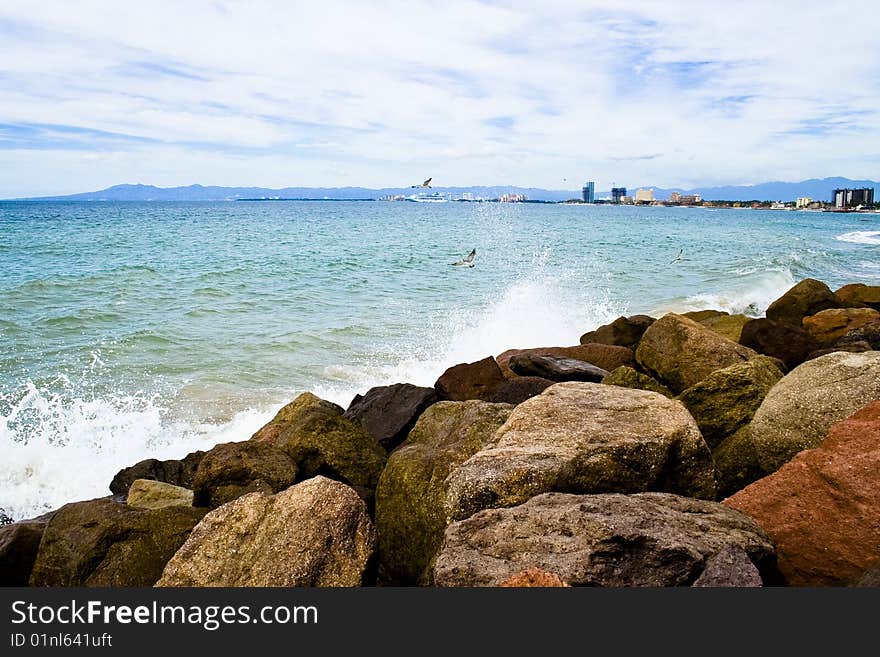 Waves breaking on rocks at a beach in Puerto Vallarta, Mexico