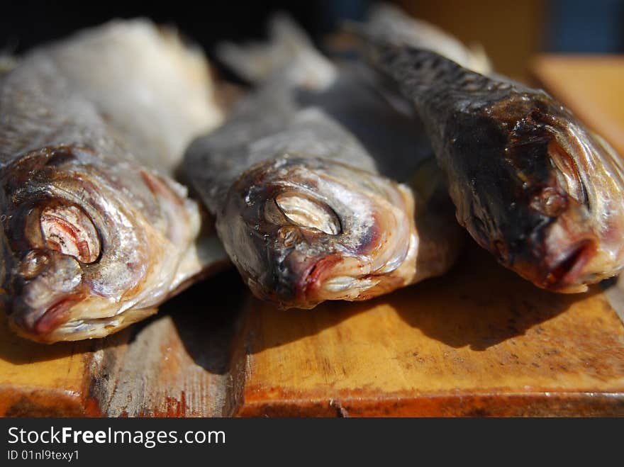 Close-up three dried fishes laying