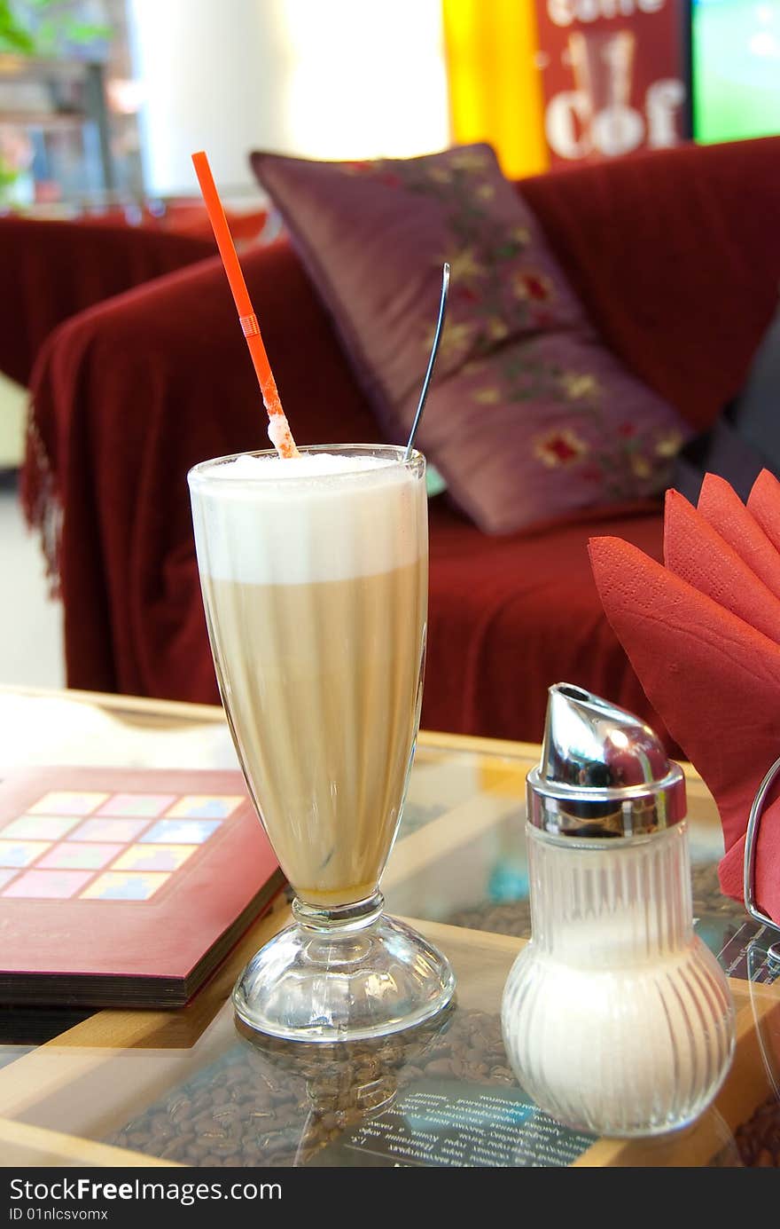 Glass with latte on a table in cafe