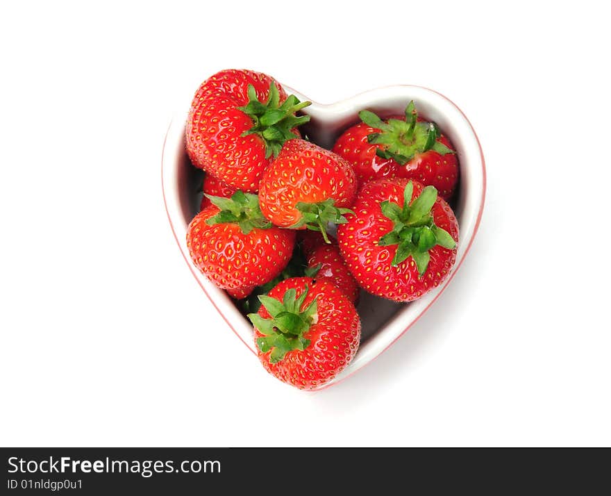 Some delicious strawberries in a heart shaped dish