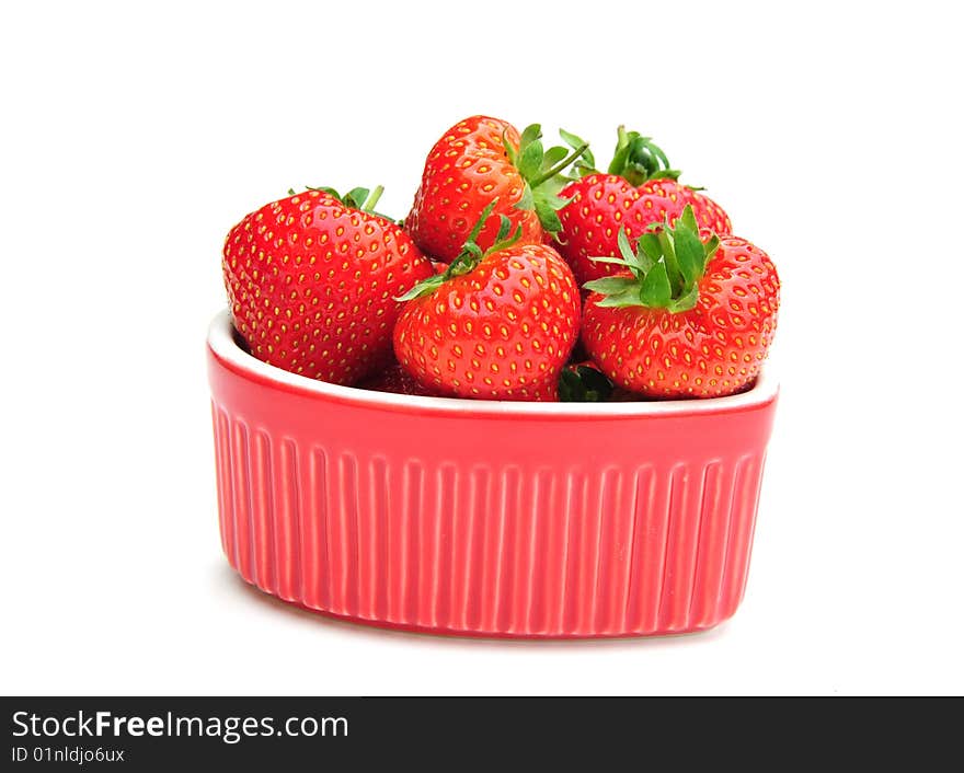 Some delicious strawberries in a heart shaped dish