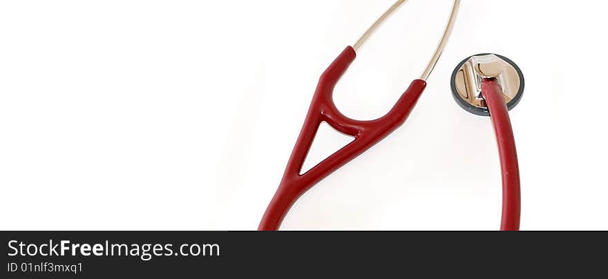 A maroon coloured stethoscope shot with a macro lens with ample copyspace to the left. A maroon coloured stethoscope shot with a macro lens with ample copyspace to the left