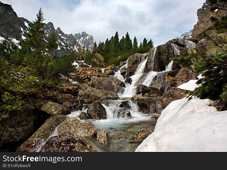 Creek in mountains, small waterfall