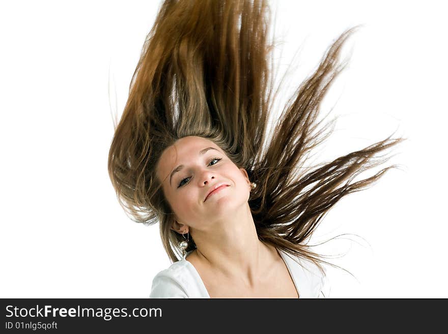 Fashion portrait of a young woman with hair lightly fluttering in the wind  on a white background. Fashion portrait of a young woman with hair lightly fluttering in the wind  on a white background