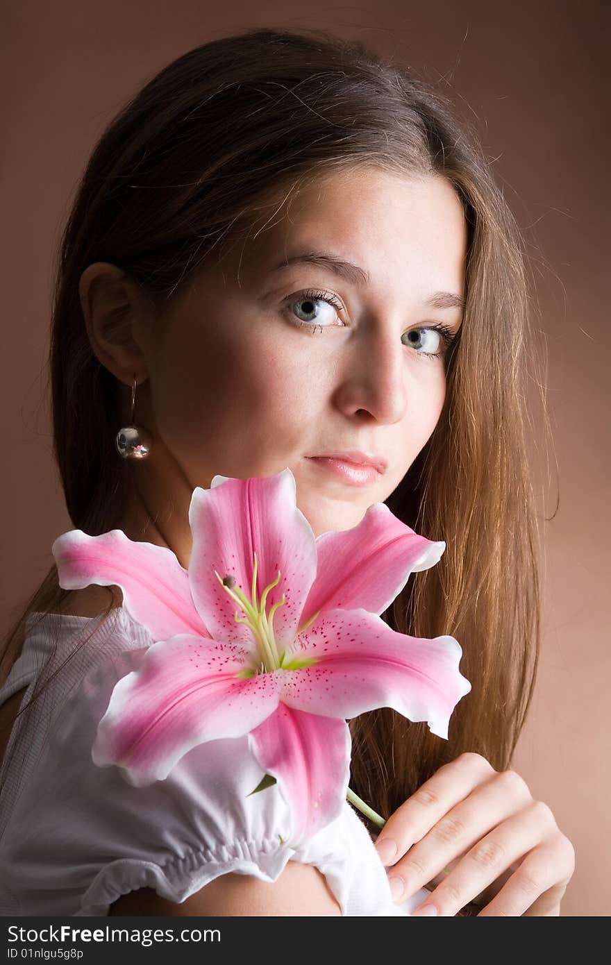 Young Woman Posing With A Pink Lily