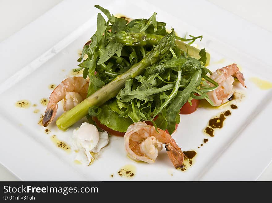 Salad from shrimps in a plate on a white background. Salad from shrimps in a plate on a white background