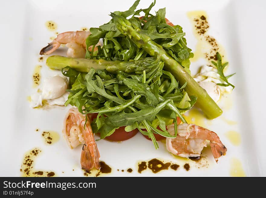 Salad from shrimps in a plate on a white background. Salad from shrimps in a plate on a white background