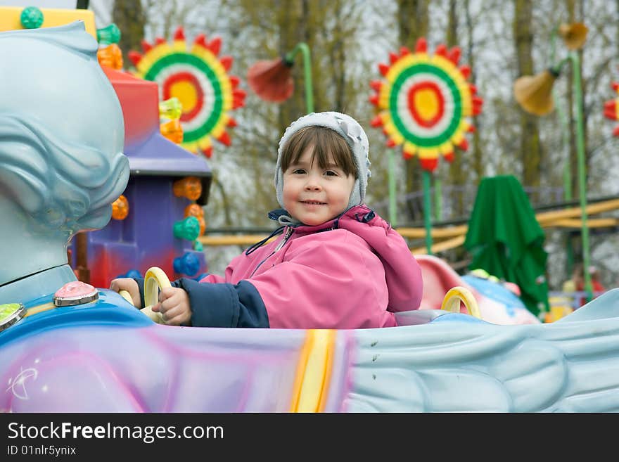 Portrait of little girl at the roundabout. Portrait of little girl at the roundabout