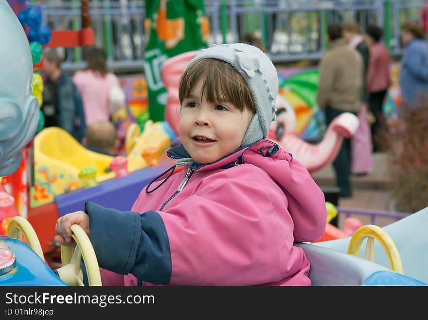 Portrait of little girl at the roundabout. Portrait of little girl at the roundabout