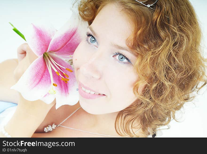 Portrait of a smiling young woman with lily flower. Portrait of a smiling young woman with lily flower