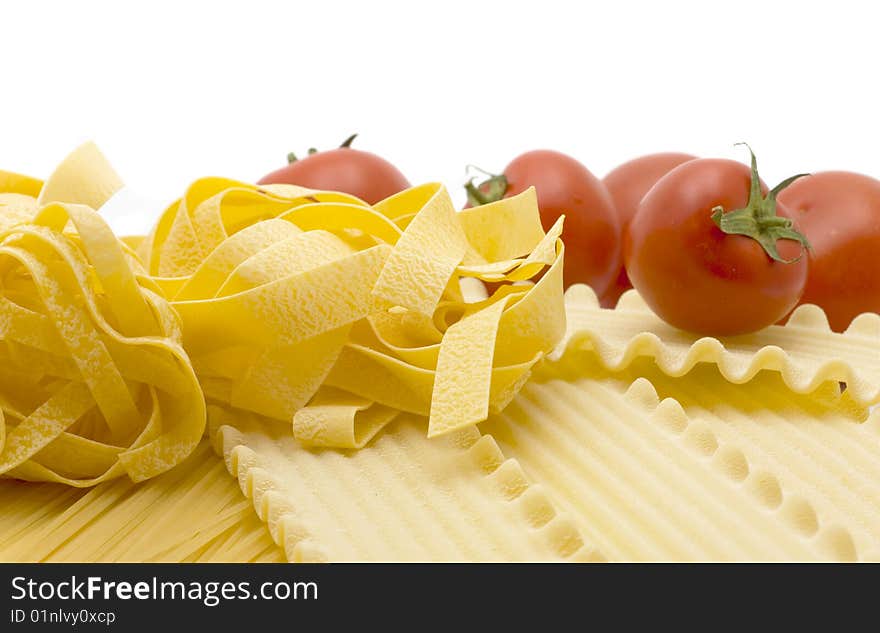 Spaghetti and mature tomato isolated on white background. Spaghetti and mature tomato isolated on white background