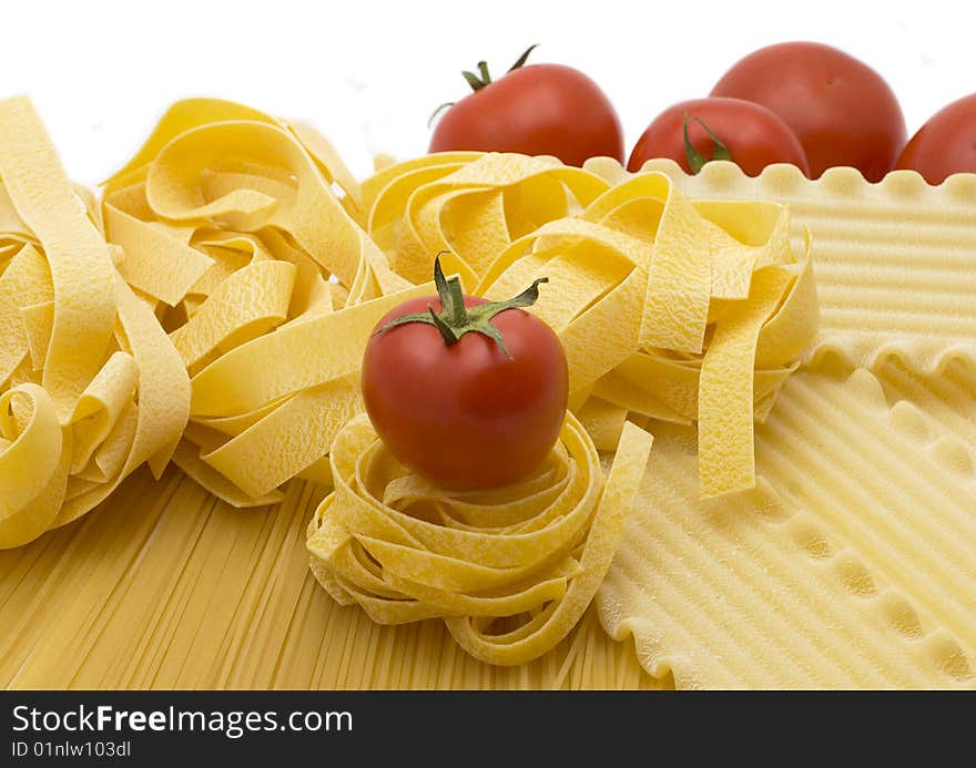 Spaghetti and mature tomatos isolated on a white background. Spaghetti and mature tomatos isolated on a white background