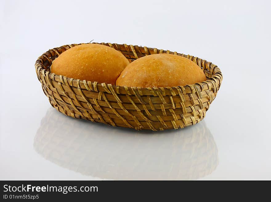 Fresh baked rolls in a basket on white. Fresh baked rolls in a basket on white