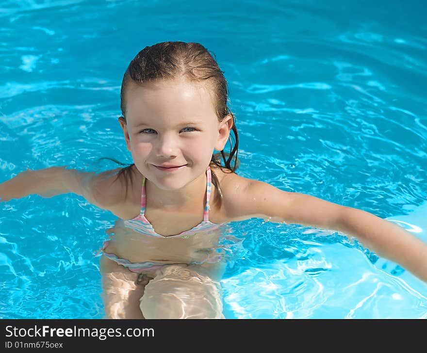 Girl in the swimming pool smiling