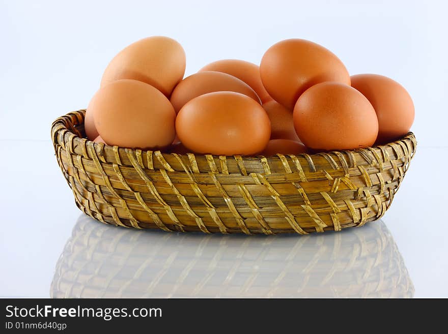 Eggs in wicker basket with white background