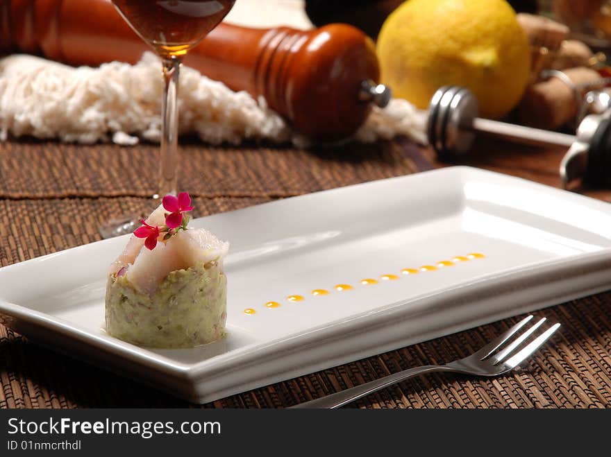 Raw fish on plate decorated with glass of wine. Raw fish on plate decorated with glass of wine