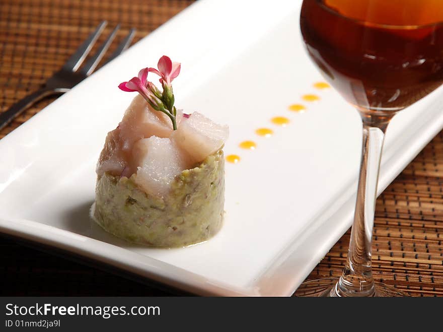 Raw fish on plate decorated with glass of wine. Raw fish on plate decorated with glass of wine