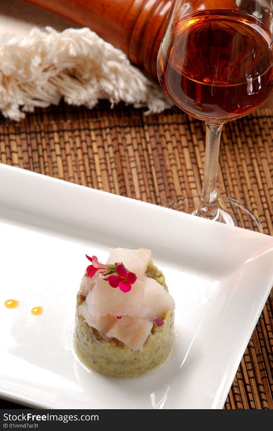 Raw fish on plate decorated with glass of wine. Raw fish on plate decorated with glass of wine