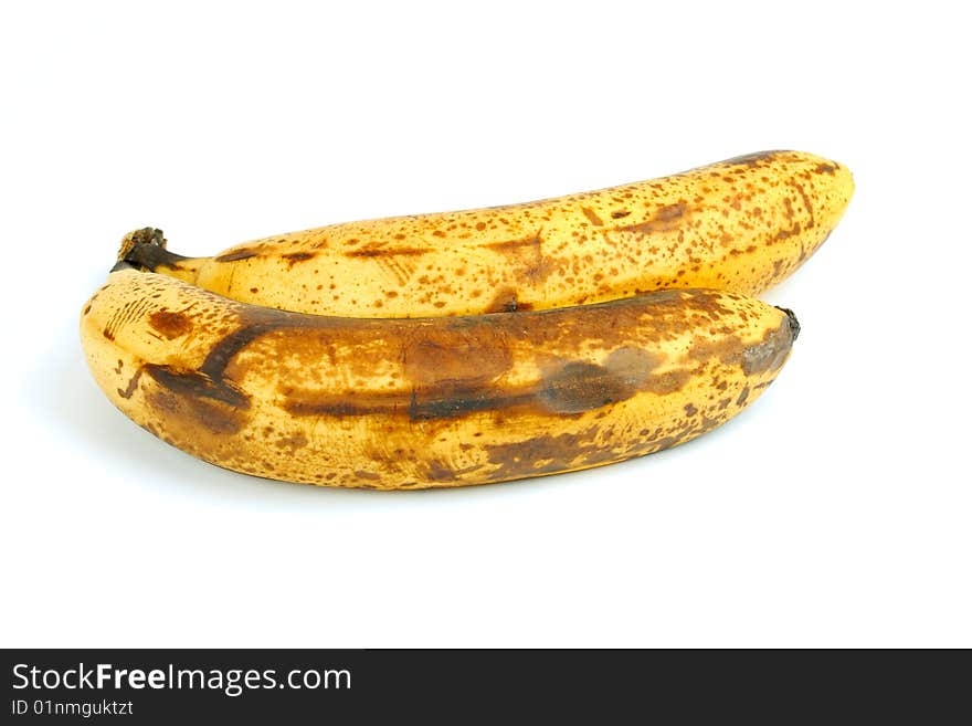 Two old bananas next to each other on a white background