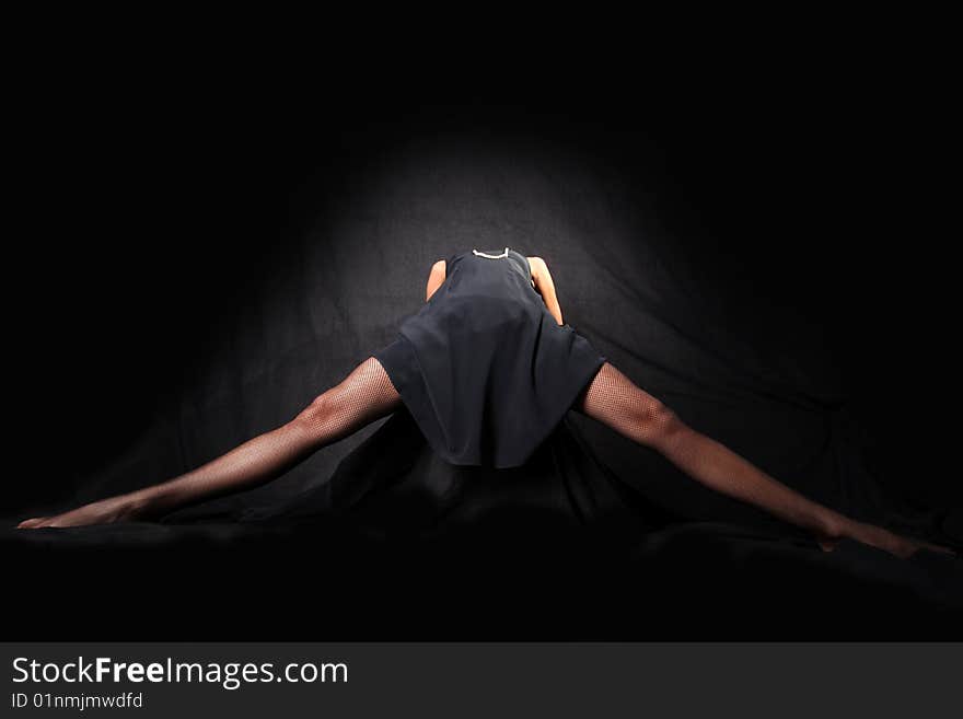 Girl with long legsl against black background