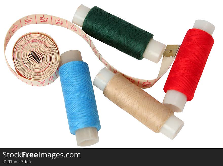 Set of coils of threads with a measured tape on a white background