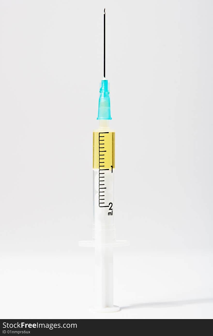 Medical syringe with a needle on a light background. Medical syringe with a needle on a light background