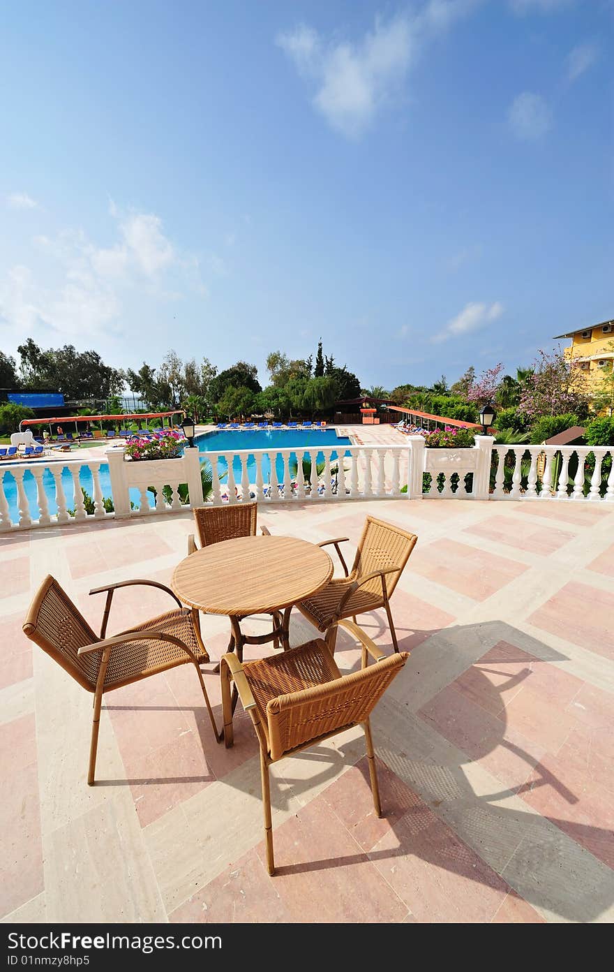 Tables and chairs near the resort's pool. Tables and chairs near the resort's pool