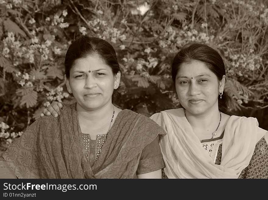 A two Indian housewives in a traditional and ethnic dress posing. A two Indian housewives in a traditional and ethnic dress posing.