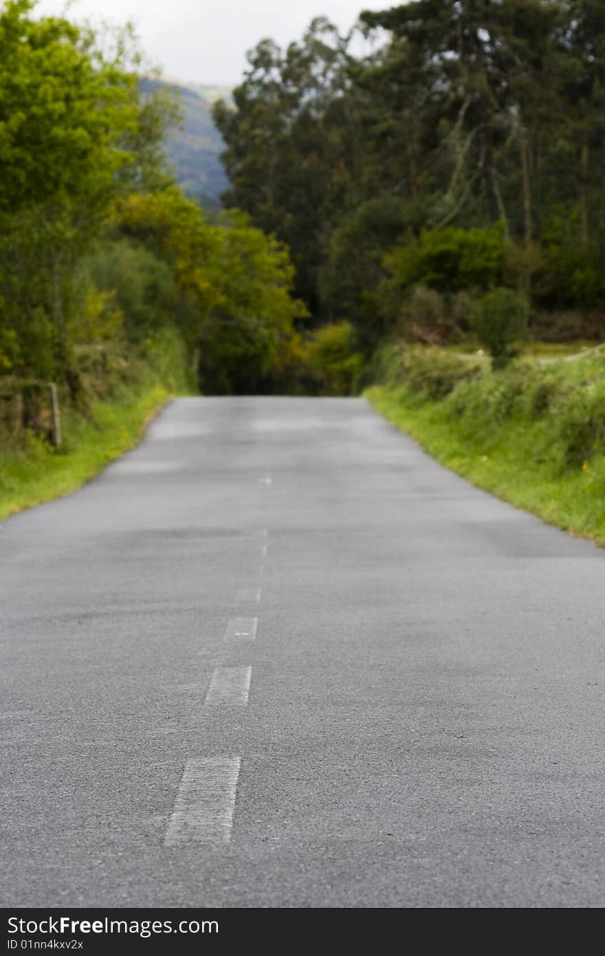 Narrow road through a country scene up a hill. Narrow road through a country scene up a hill