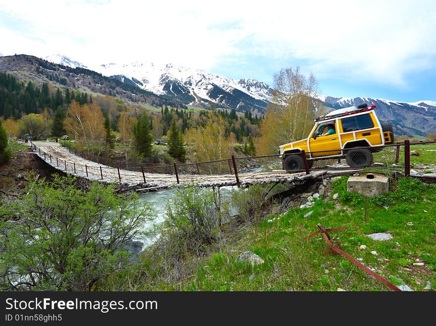 The old bridge through the mountain river