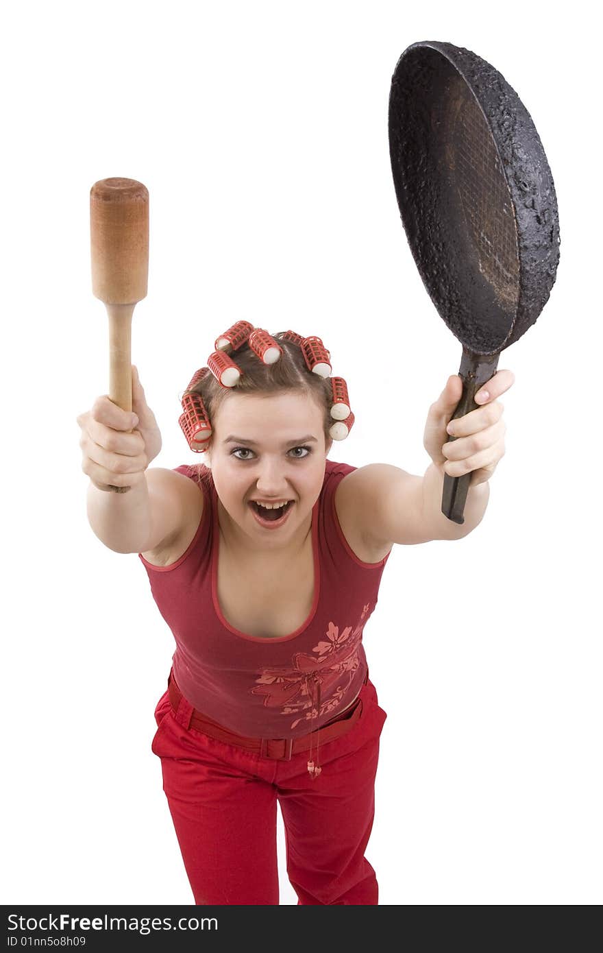 Housewife with curlers in her hair, holding a frying pan. Woman in hair rollers with an angry expression. Angry girl in hair rollers. Isolated over white background. Housewife with curlers in her hair, holding a frying pan. Woman in hair rollers with an angry expression. Angry girl in hair rollers. Isolated over white background.