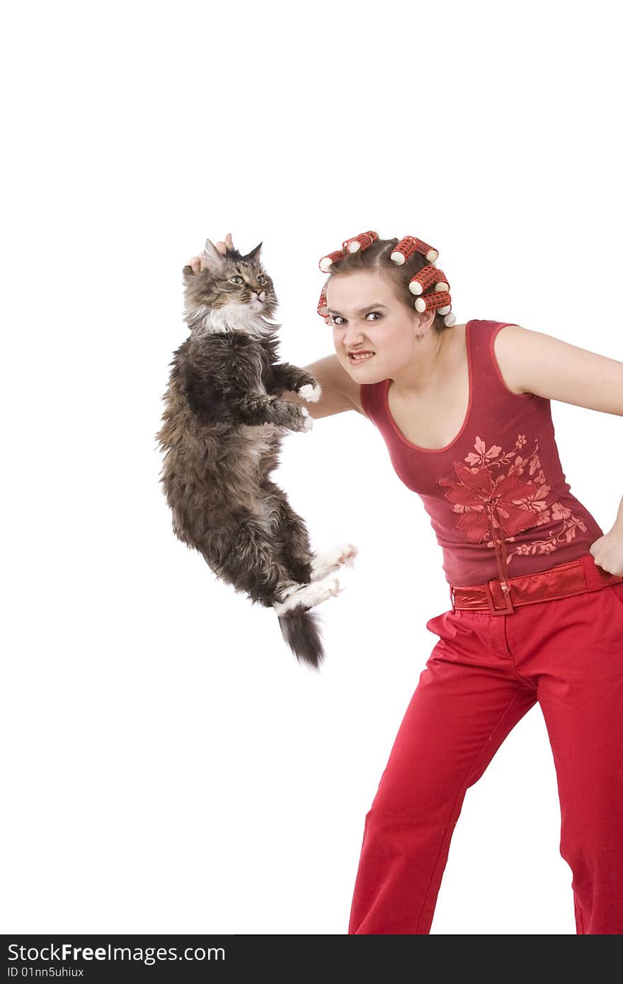 Portrait of a young girl with an angry expression. Very frustrated and angry mad woman. Angry look on face. Housewife is holding soil cat.  The cat leaves droppings.